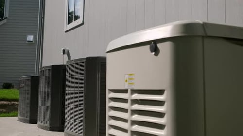 HVAC Condensers and Generator Outside Suburban Home