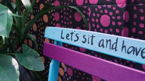 Colorful Wooden Bench With Message In The Alleyway In Sydney, Australia. Tracking Shot