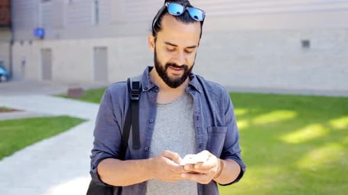 Man Using Smartphone on City Street