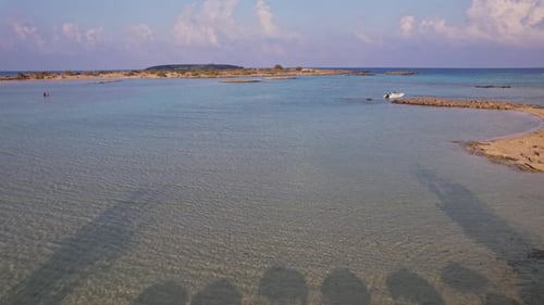 Tranquil beach with straw umbrellas and calm waters in sunny weather