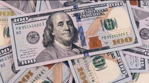 100 dollars bills close-up, slowly rotating background in a pile of hundreds of American US dollars.