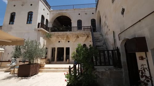 Ornate Historic Building with Stone Courtyard and Stairs