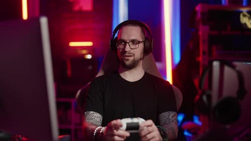 Young Adult Gamer Playing Video Game At Home