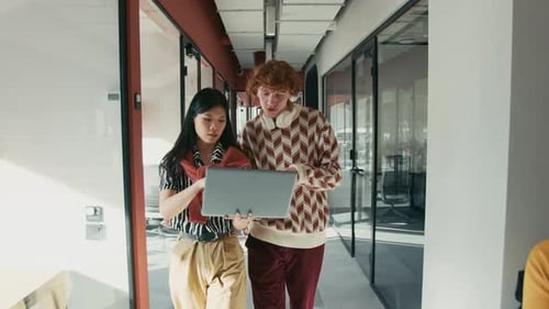 Colleagues Discussing Project in Modern Office