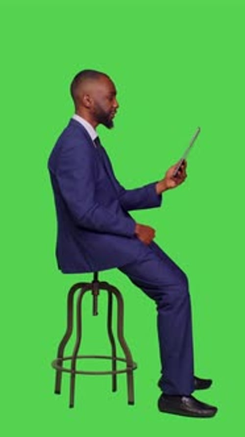 Man on Tablet Video Conferencing on Green Screen