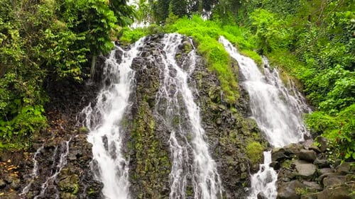 Tropical Waterfall Cascading Down Rocky Mountainside