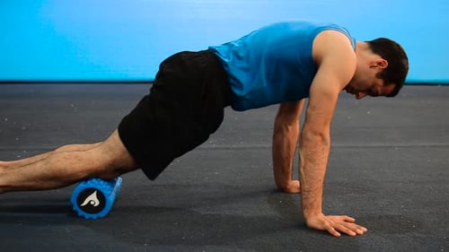 Man Using Foam Roller to Stretch Leg Muscles