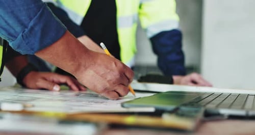 Architects Collaborate on Building Design in Office