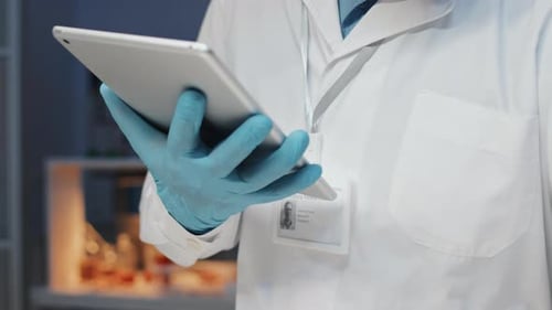 Scientist Using Tablet in Lab with Petri Dish
