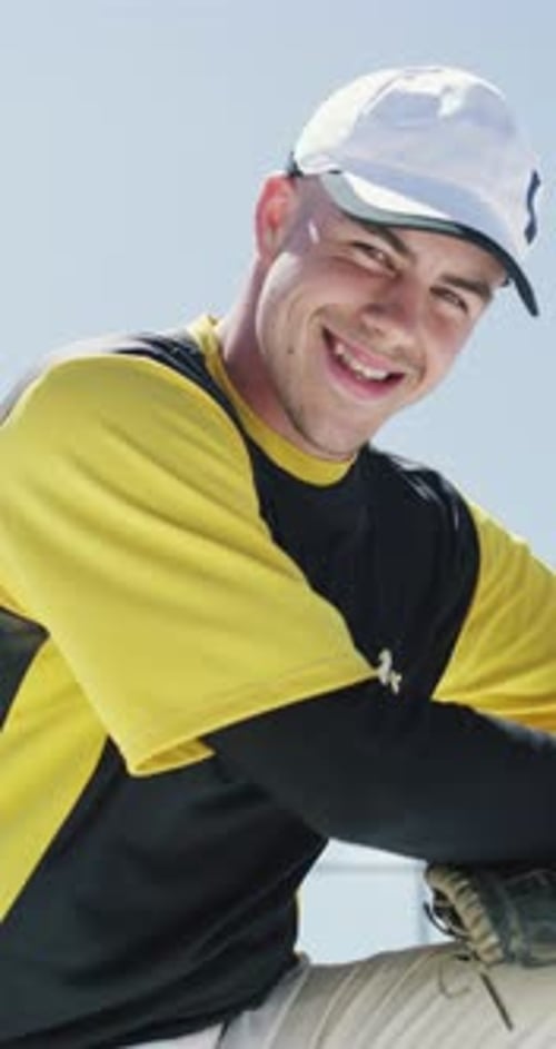 Face, man and baseball pitcher with smile at sports park, fitness and confidence for competition