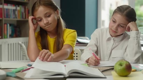 Sad Caucasian Two Little Girls Children Struggling Difficult Task at Desk in Class Frustrated