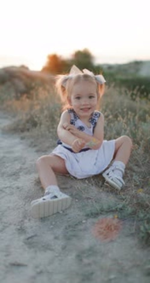 Cute Caucasian Child Girl Outdoor with Evening Sunlight