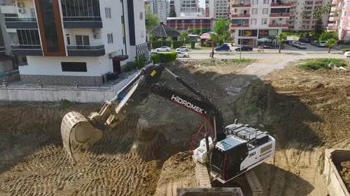 Construction Kickoff Aerial of Soil Removal By Excavators and Trucks