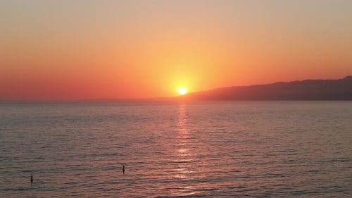View of the Sun Setting on the Horizon with an Orange Sky From Santa Monica Pier