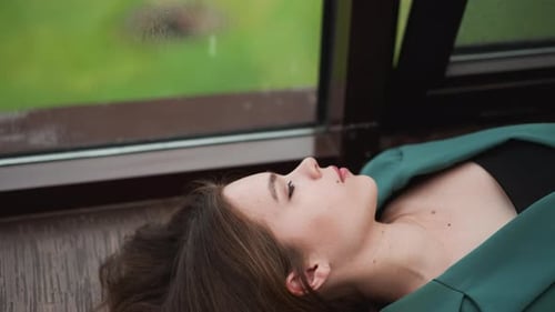 Woman Relaxing Indoors Near Window