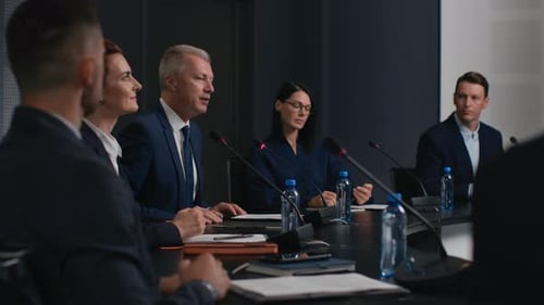 Speech Of Political Speaker At Meeting Room Of Modern Business Center. Man In Suit Explaining Lea...