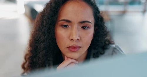 Thoughtful Woman Working at Computer in Office