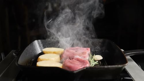 Steak and Potatoes Sizzle in Cast Iron Pan