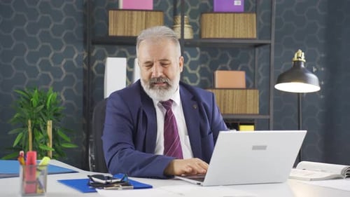 Mature Man Working at Desk in Corporate Office