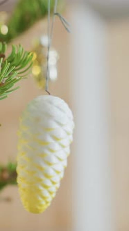 Decorative Pinecone on Festive Tree with Soft Lighting Close View of Frosted Pinecone Ornament