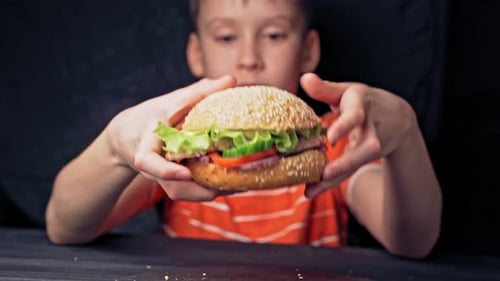 Teen Boy About to Eat a Burger