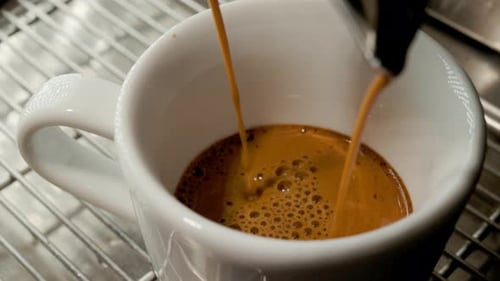 Fresh Espresso Pouring Into White Ceramic Mug
