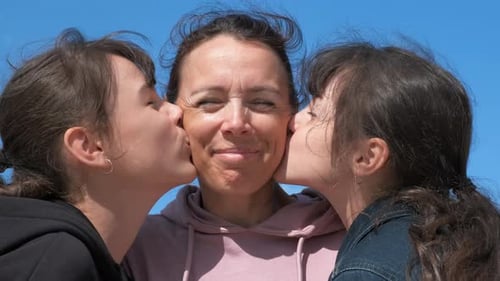 Mother Gets Kisses From Her Daughters