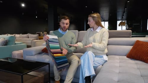 Couple Choosing Fabric Swatches in Furniture Showroom