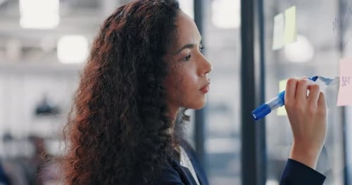 Businesswoman, writing and planning schedule for strategy, brainstorming or tasks at office