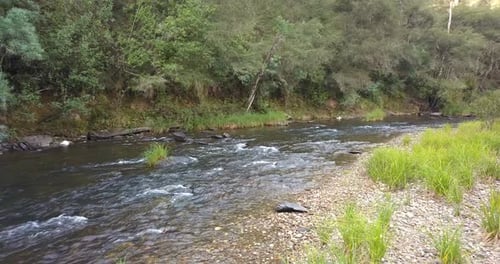 River flowing through a valley in mountain foothills (aerial view)