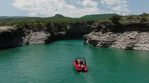 A Boat in the Water Amidst the Vastness of a Crystal Blue Lake a Lone Boat Glides Through the Serene