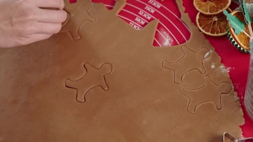 Cutting Gingerbread Men Out of Cookie Dough