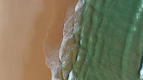 Tropical beach aerial view, Top view of waves break on tropical yellow sand beach. Sea waves seamles