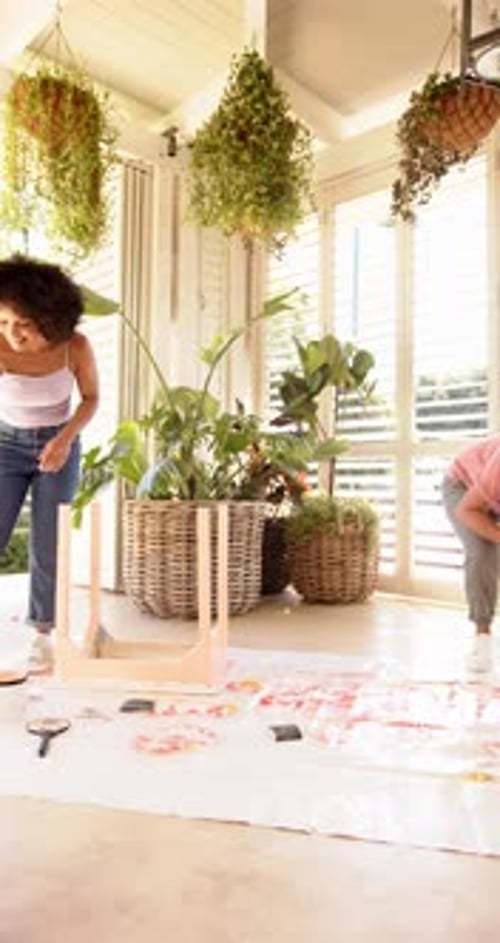 Women Collaborating on Art Project on Porch