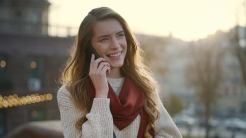 Smiling Woman Talking on Mobile Phone Outdoors