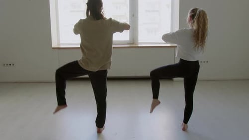 Dancers Doing Hip Opener Exercise in Studio