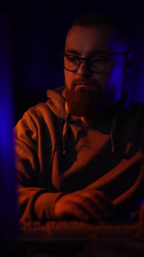 Vertical View of Cyber Security Expert From 1990's Working on Computer in Dark Room