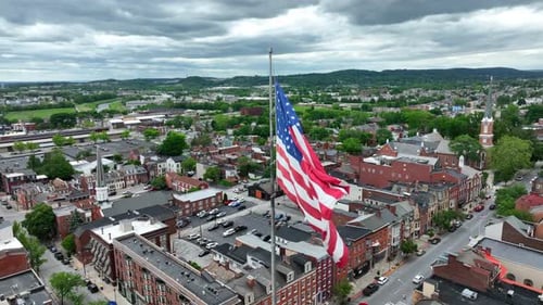 American Flag Waving over a Picturesque Cityscape