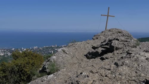 Landscape View on Rock with a Cross in the Mountains