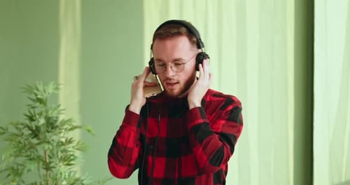 Man Listens and Dances to Music on Phone
