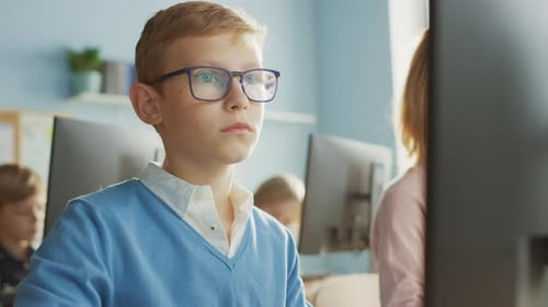 Elementary School Computer Science Classroom: Portrait of a Smart Boy Using Personal Computer, Lear