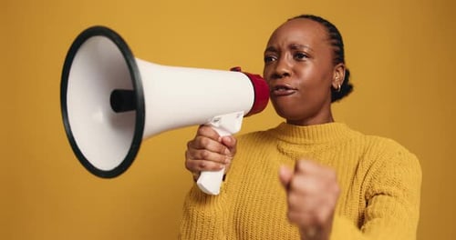 Megaphone, screaming and black woman in studio for protest, democracy or human rights activism