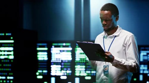 Young Adult Standing in Front of Data Servers