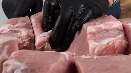 Preparing Raw Pork Chops on a Cutting Board