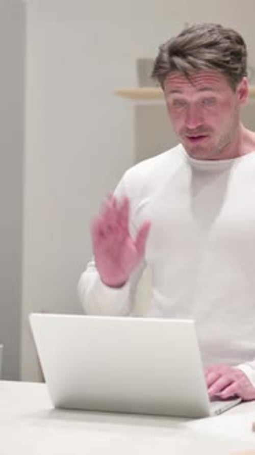 Man Video Calling on Laptop from Home