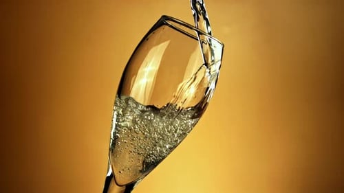 Champagne Poured into Glass with Bubbles and Celebration