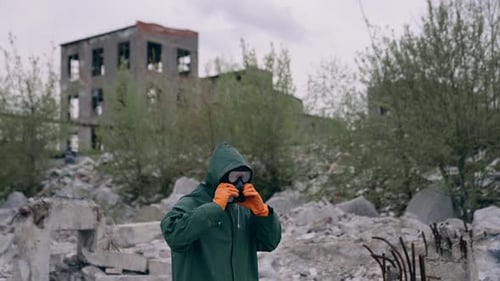 Radiation ecological disaster safety. Man in biohazard suit working in ruined city.
