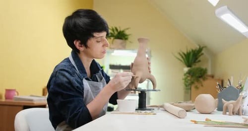 Woman Sculpts Vase From Clay By Hands Closeup in Artistic Studio