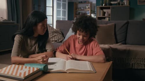 Army Soldier Mother Helping Young Son with School Homework