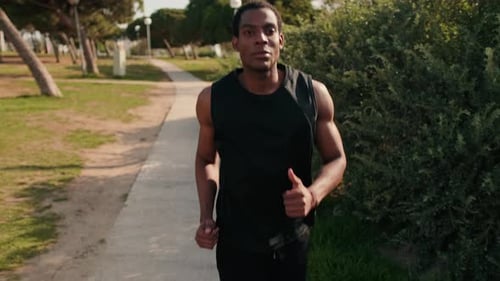 Young Man Running in the Park